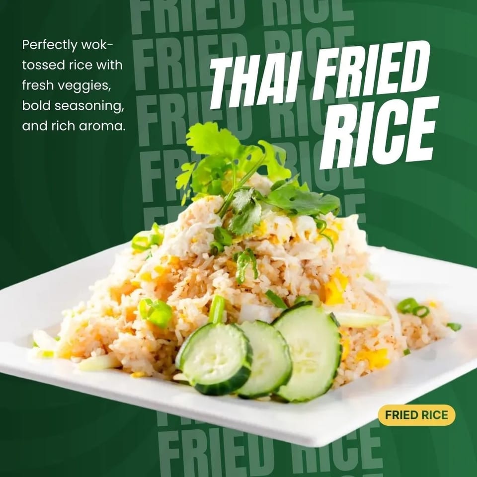A plate of Thai fried rice garnished with fresh cilantro, green onions, and cucumber slices.